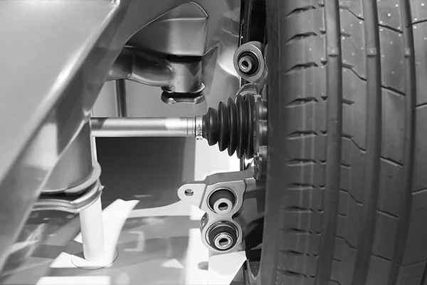 Close-up of suspension system behind wheel