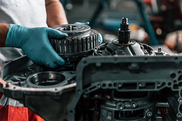 A technician working on a transmission