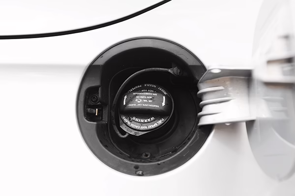 Closed gas cap on white vehicle