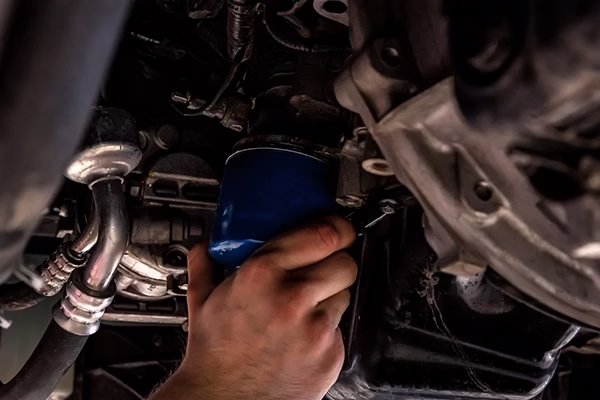 Technician installing oil filter